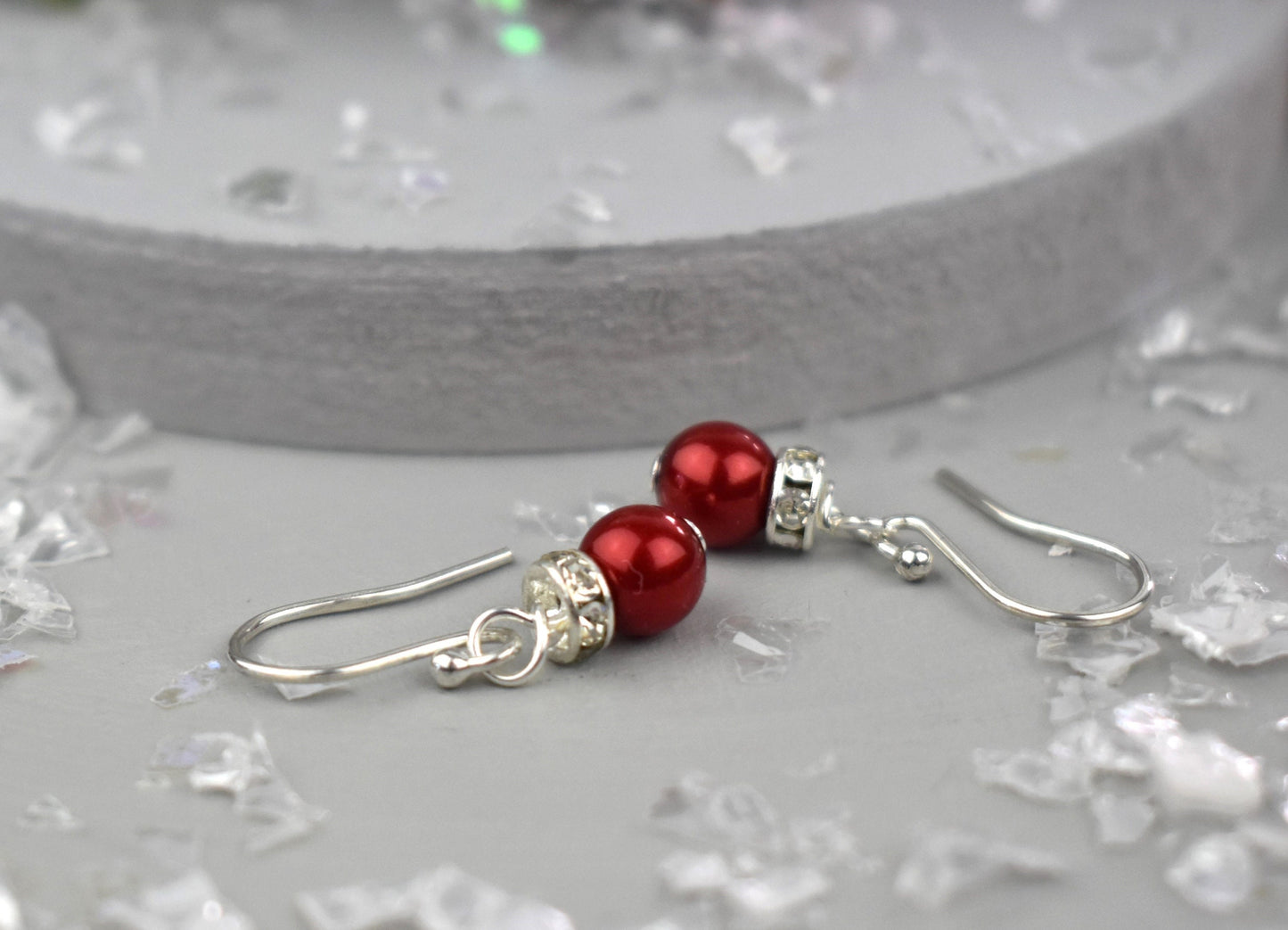 High quality glass pearl topped with a silver sparkling rondell bead and suspended from sterling silver ear wires. Christmas bauble earrings.