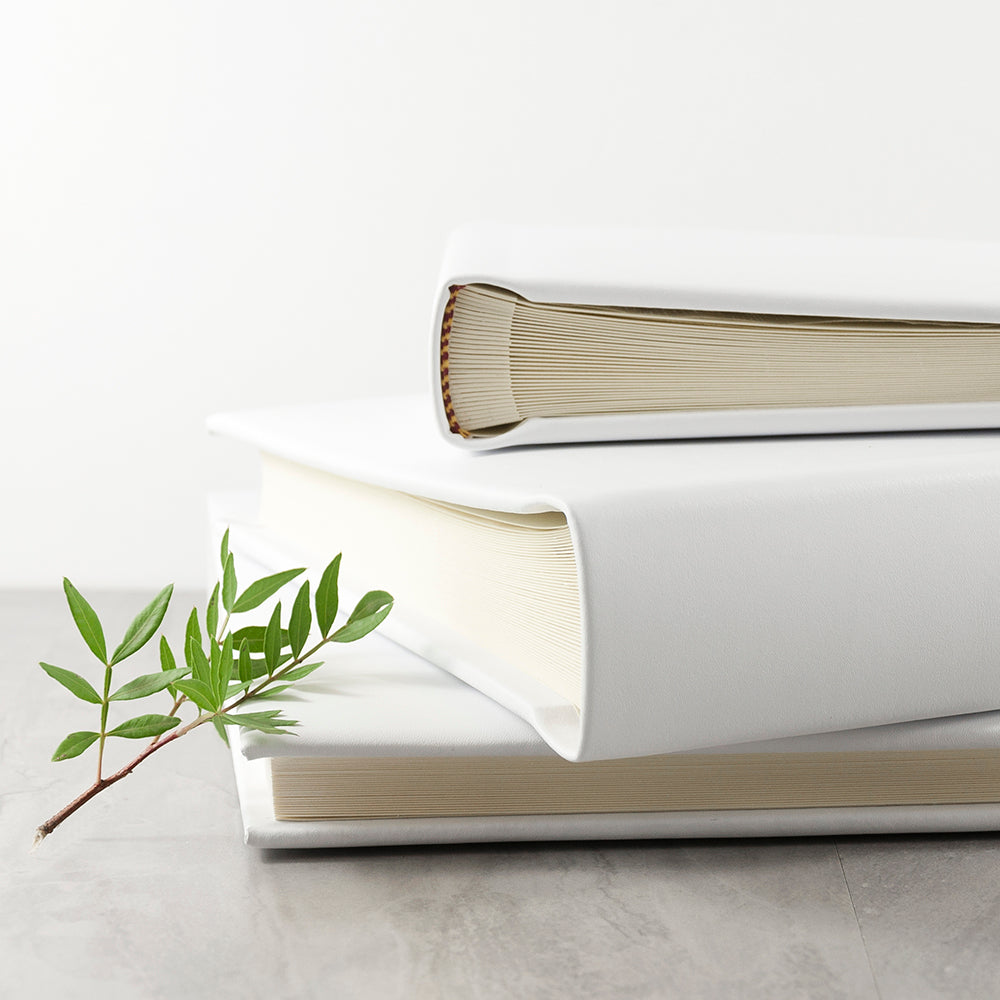 Stack of white leather photo album showing available sizes