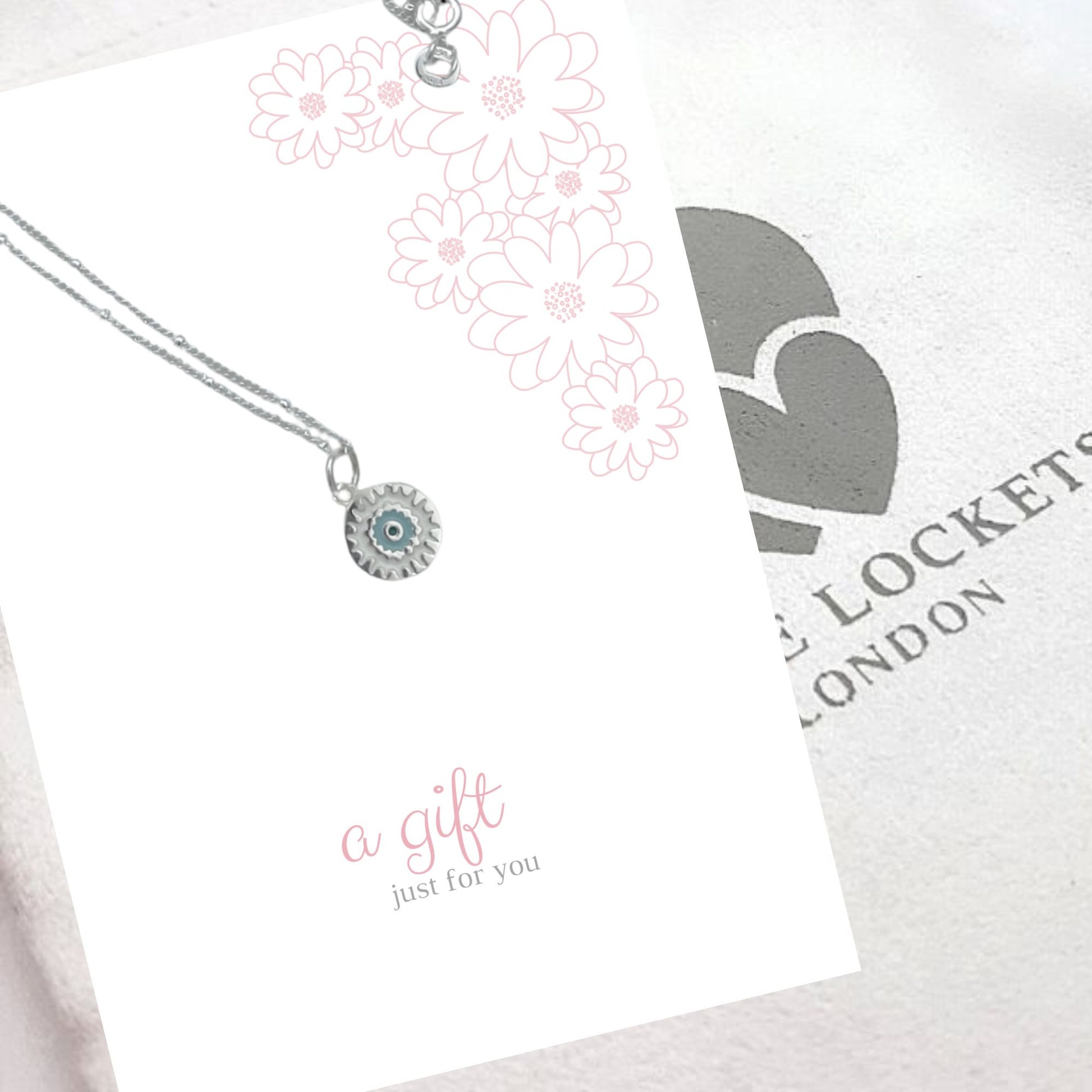 Sterling silver mandala pendant shown on pink gift card "A gift for you" and with luxury gift pouch
