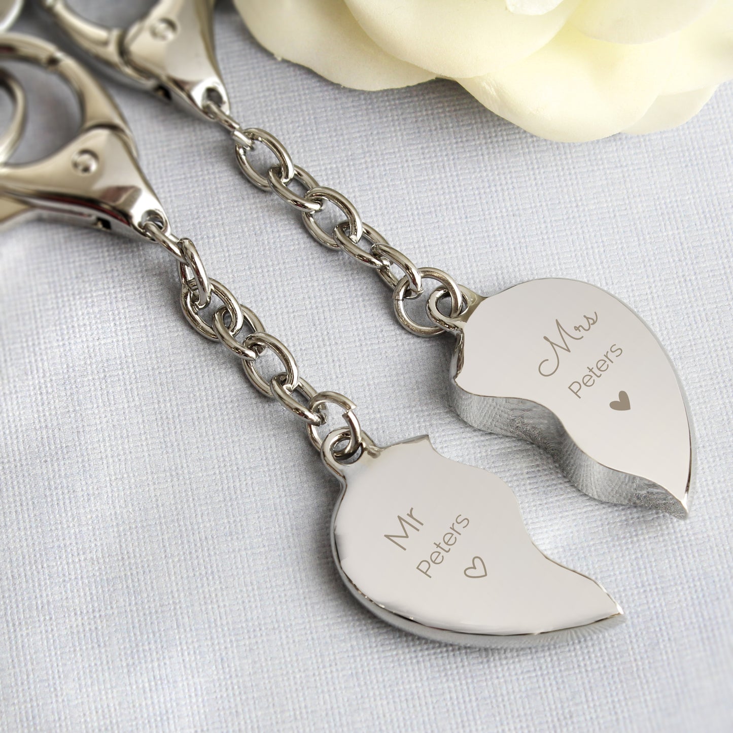 Two key rings when joined together form a heart. Each keyring is personalised with Mr or Mrs and the surname of your choice.