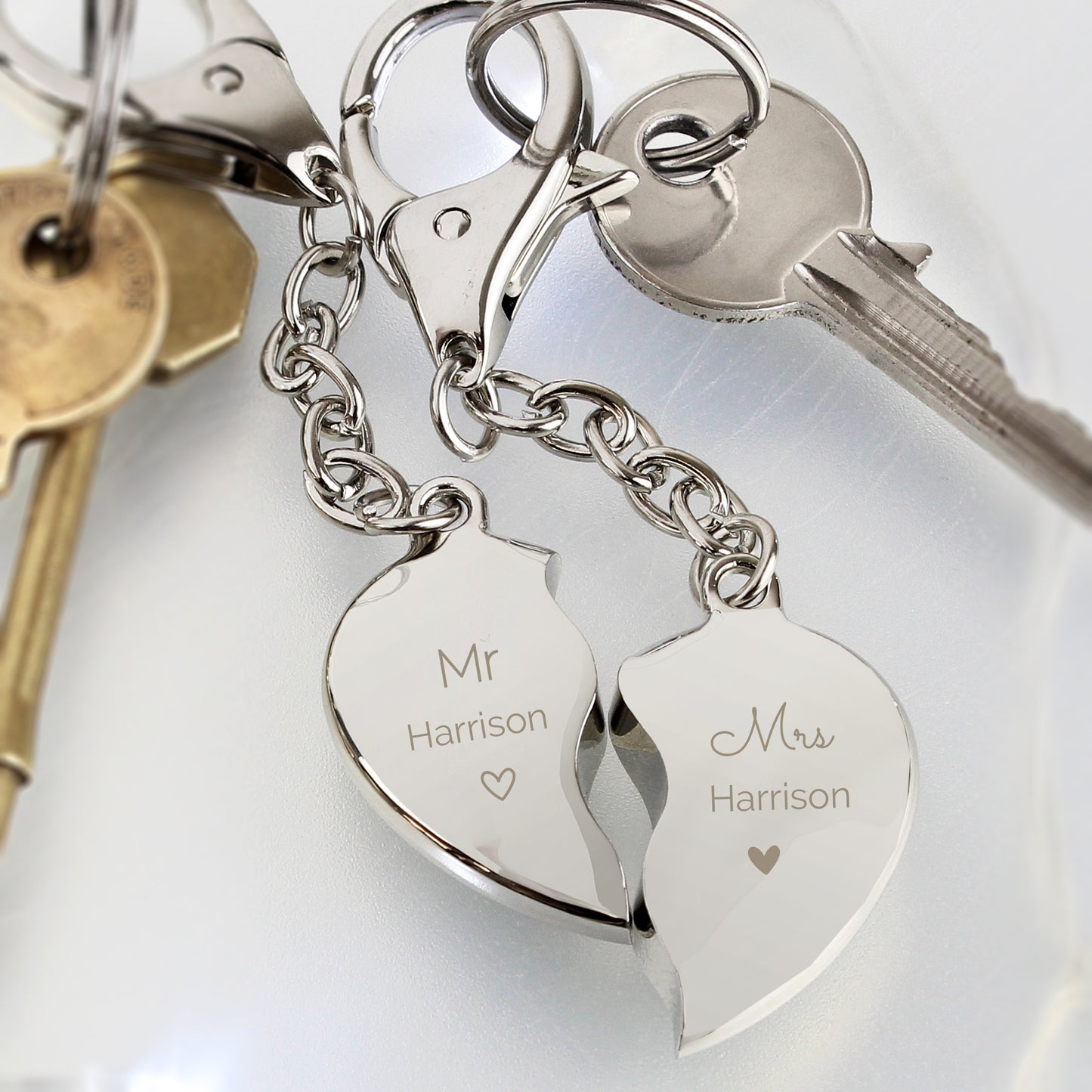 Two key rings when joined together form a heart. Each keyring is personalised with Mr or Mrs and the surname of your choice.