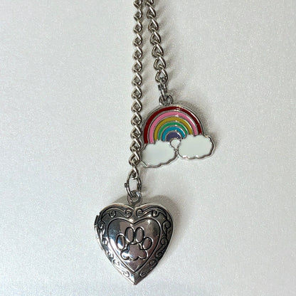 Heart shaped locket with paw print is teamed with a rainbow bridge charm, part of the pet memorial keyring