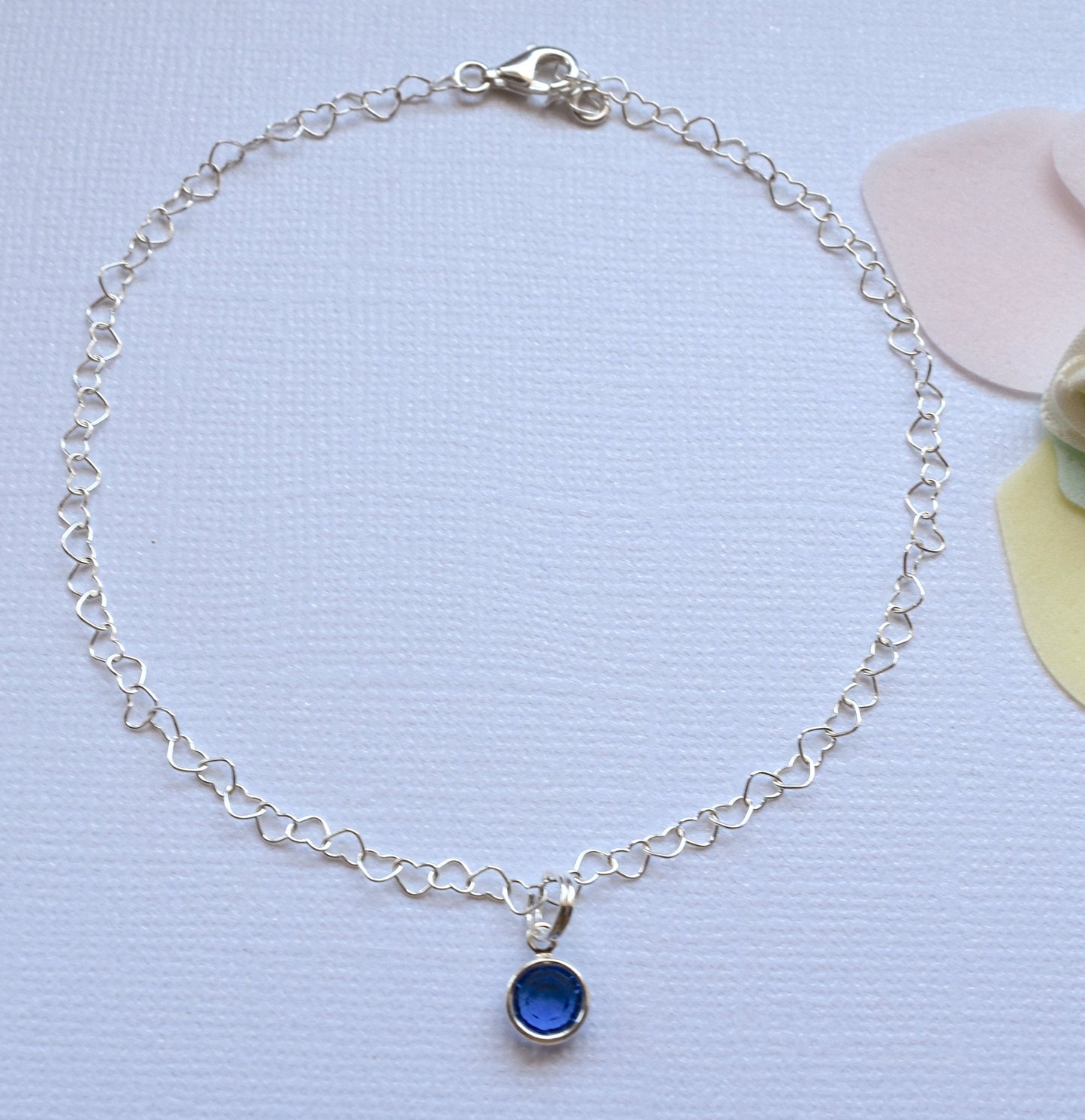 anklet with heart shaped links and blue stone
